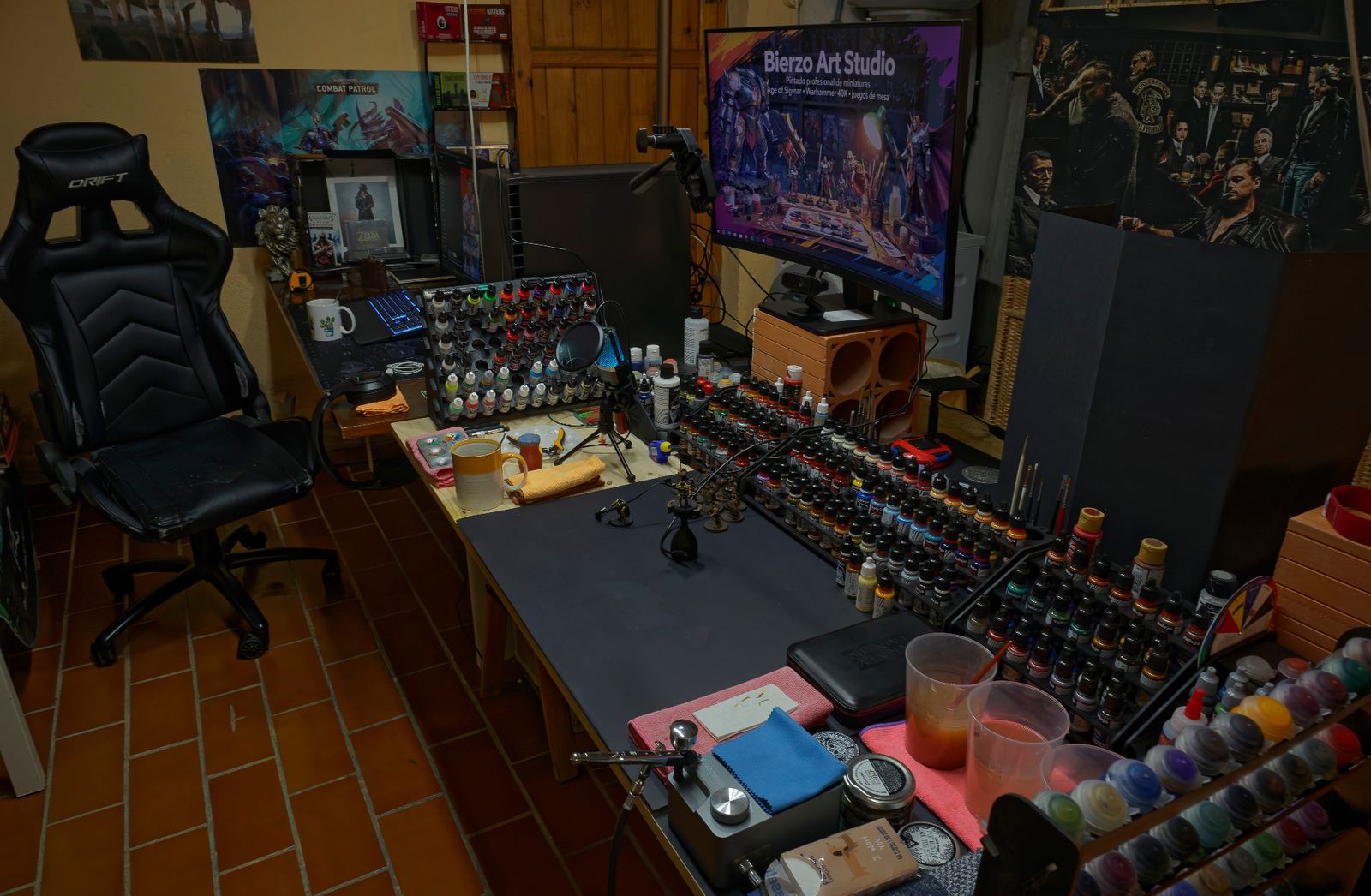 Riky de Bierzo painting the gold details on a fantasy miniature in the studio